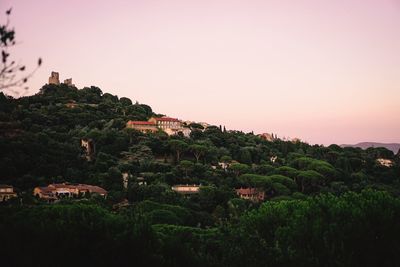 Buildings against clear sky during sunset