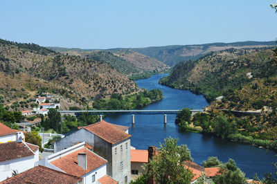 High angle view of river and buildings against sky