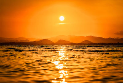 Scenic view of sea against romantic sky at sunset