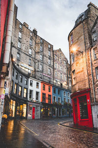 City street by buildings against sky