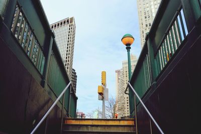 Low angle view of street light against buildings
