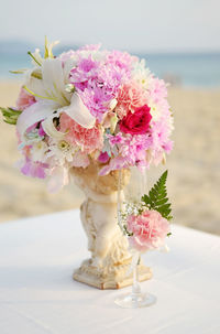 Close-up of pink flower vase on table