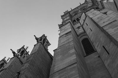 Low angle view of statues on building against sky