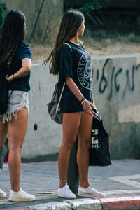 Full length of woman standing on street in city