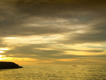 Scenic view of sea against cloudy sky