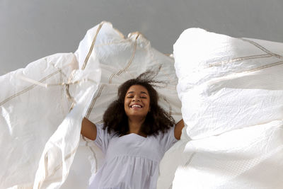 Low angle portrait of teenager girl holding textile