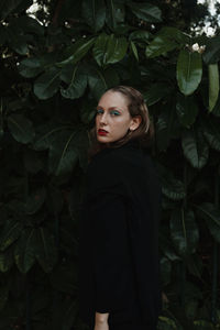 Portrait of a beautiful young woman standing outdoors