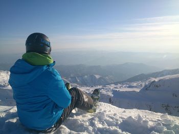 Tourists on snow covered mountain