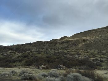 Scenic view of mountains against cloudy sky