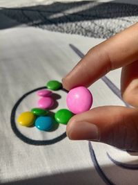 Close-up of hand holding multi colored candies