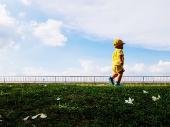 Boy on land against sky