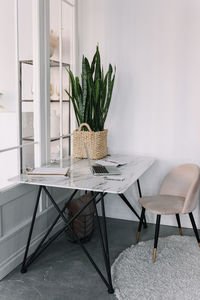 Bright modern office interior with a desk chair and appliances on the table at home