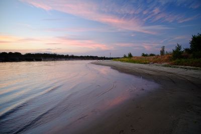 Scenic view of beach against sky during sunset