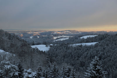 Scenic view of snowcapped mountains against sky at sunset