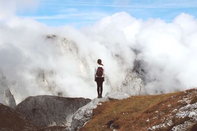 Full length of woman standing on mountain against sky