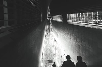 People in illuminated tunnel
