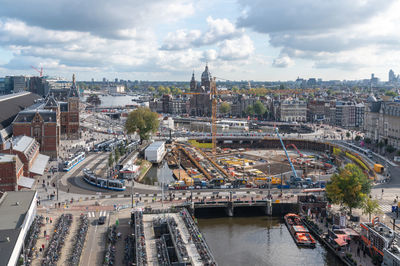 High angle view of bridge over river amidst buildings in city