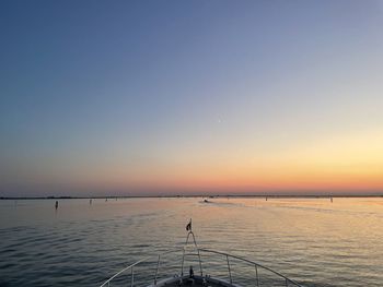 Scenic view of sea against clear sky during sunset