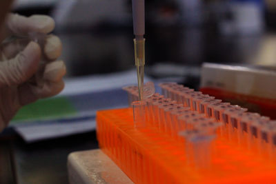 Cropped hand of scientist examining chemical in laboratory