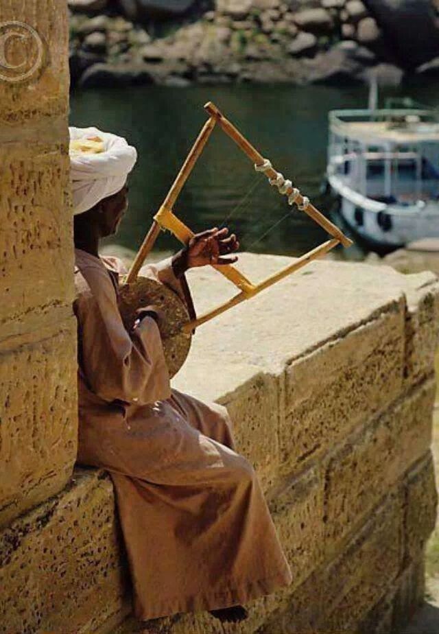 focus on foreground, water, art and craft, creativity, outdoors, art, day, nautical vessel, railing, men, rope, metal, human representation, leisure activity, close-up, sitting, selective focus, incidental people