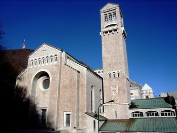 Low angle view of historic building against clear blue sky