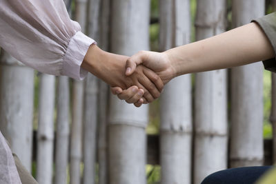 Midsection of man holding hands