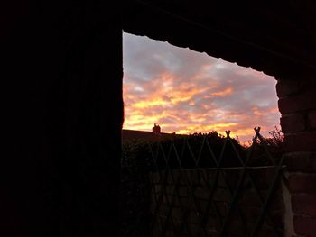 Silhouette built structure against sky during sunset