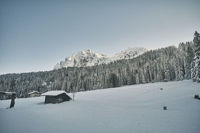 Scenic view of snow covered mountains against clear sky