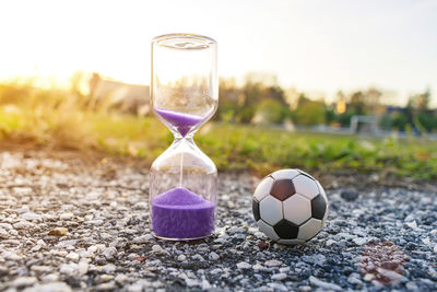 Close-up of hourglass on field