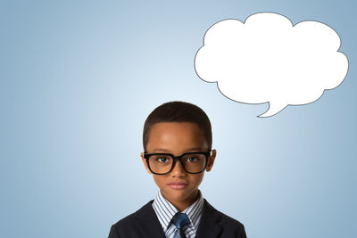 Portrait of boy against blue background