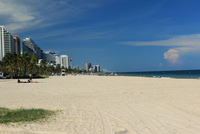 Panoramic view of beach and buildings against sky