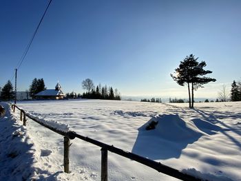 Snow covered field against sky