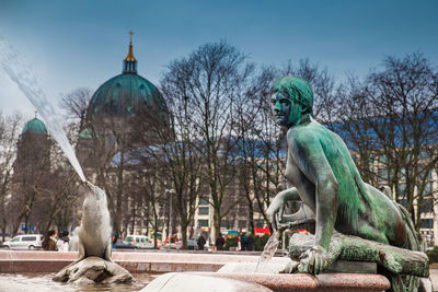 The antique neptune fountain built in 1891 designed by reinhold begas in a cold end of winter day