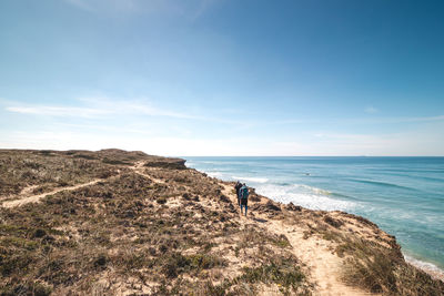 Scenic view of beach against blue sky