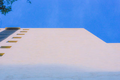 Tilt image of building against blue sky