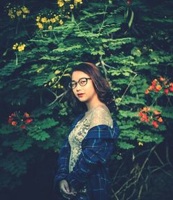 Portrait of woman holding plant