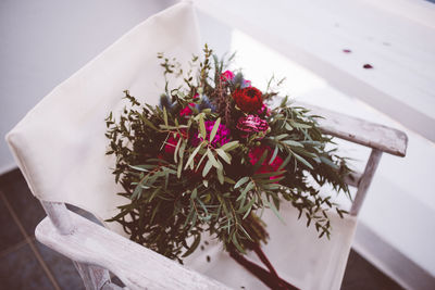 High angle view of flowers on chair