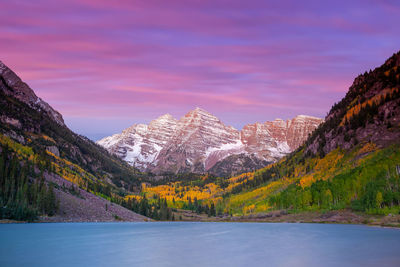 Scenic view of lake by mountains against sky