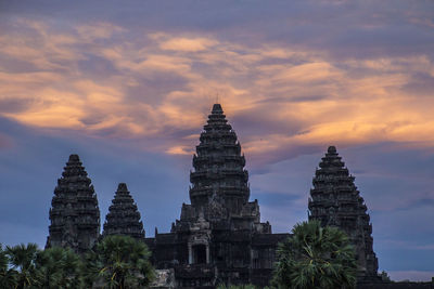 Historic building against sky at sunset