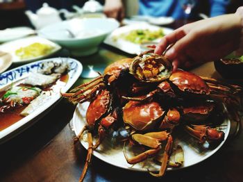 Close-up of person preparing food in plate