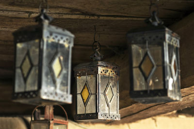 Low angle view of vintage lanterns hanging in old mud house