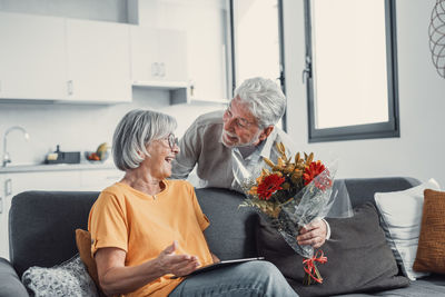 Side view of senior woman sitting at home