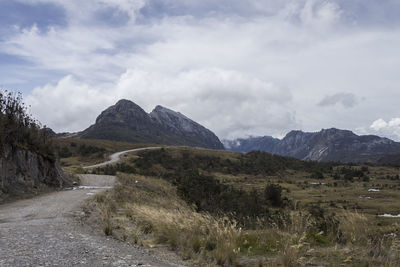 Scenic view of mountains against cloudy sky