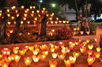 Multi colored lit candles on temple at night