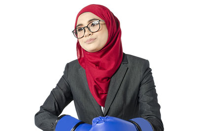 Portrait of smiling young woman against white background