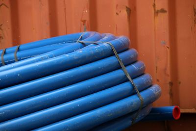 Close-up of pipes against metal wall