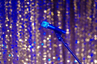 Microphone against defocused lights at nightclub