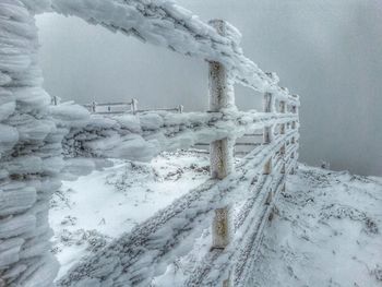 Icicles on snow covered fence