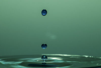 Close-up of drop falling on water