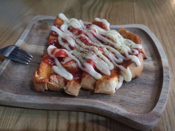 High angle view of bread on cutting board